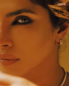 a close up of a person with jewelry on their neck and the cover of a magazine