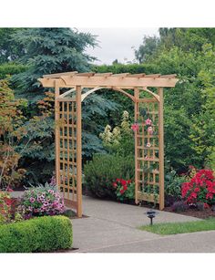 a wooden arbor in the middle of a garden