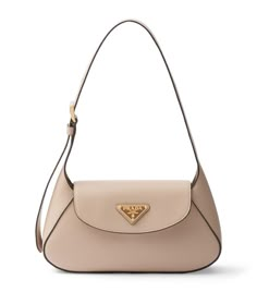 Defined by harmonious lines and an elegant sensibility, this Prada shoulder bag infuses an Italian je ne se quoi into perennial ensembles. Notice how the enamel logo, although triangular, lends the perfect accompaniment to the curved silhouette – the centrality and balance it provides will garner you attention from every fashion maven. Universe Fashion, Freetime Activities, Bag Closet, Ballet Clothes, Love Luxury, Prada Shoulder Bag, Handbags Luxury