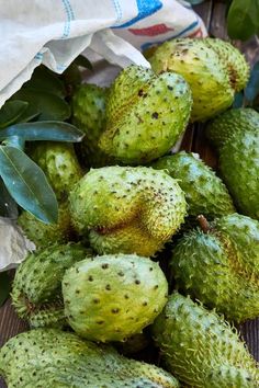 the green fruit is sitting on the wooden table and ready to be picked from the tree