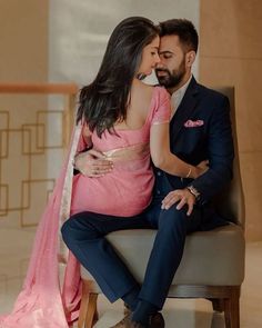 a man and woman sitting next to each other on a chair