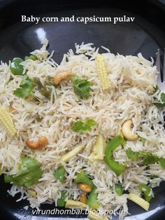 a black plate topped with rice and veggies