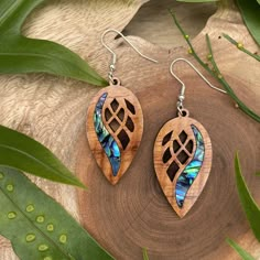 **ALL ITEMS ARE MADE TO ORDER, AND REQUIRE 5-7 BUSINESS DAYS TO COMPLETE BEFORE SHIPPING** Our earrings are made with the highest quality hand milled, laser cut Hawaiian Koa, from the Big Island's Kona side. These earrings include an abalone veneer inlay. This design is .9 inches wide by 1.7 inches high by .1 inches thick. We manufacture our own Koa sheets in very small batches, using reclaimed wood from the offcuts from local wood mills, and as such, each batch of Koa has wide variations of character. The pair of earrings you receive may differ slightly in look from the pictures in the listing, but we use only the finest Koa for our earrings and pendants. All of our earring hooks are high quality silver plated stainless steel, and are nickel-free and hypoallergenic. Our earrings are finis Laser Necklace Design, Wood Earrings Diy, Laser Engraved Earrings, Wood Jewelry Diy, Laser Cut Wood Earrings, Laser Cut Wood Crafts, Wooden Jewellery, Filigree Pattern, Laser Cut Earrings