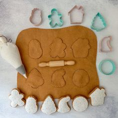 the cookie cutters are next to an oven mitt and doughnut molds