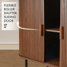 a wooden cabinet sitting on top of a hard wood floor next to a white sign that says flexible roller shutter sliding door