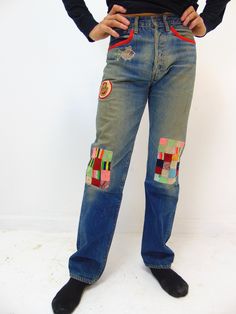 "These are a unique vintage pair of red line levi men's jeans from the 1970's.  They were customized back in the 70's and maybe even later where the bottom part of the legs is from a different jean.  These are a bit fragile and can tear and break easily.  There are some holes in the pants.  One on the rear end and some by the hip area.  Our model states that these feel like a \" 30'' waist and a 31'' length\" When we lay them down to measure across the pants we have: 15.5'' across the waist 29'' inseam 8'' opening at base of the pant leg 9'' across the thigh area I have many more photos if you are an interested buyer and would like to see more, please let me know and I will be glad to send them to you. Ships via FED EX with Insurance to the usa states" Red Retro Denim Bottoms, Fitted Retro Recycled Denim Bottoms, Vintage Straight Leg Recycled Denim Pants, Retro Fitted Bottoms In Recycled Denim, Vintage Red Wide Leg Jeans, Vintage Red Wide-leg Jeans, Vintage Wide Leg Red Jeans, Retro Fitted Patchwork Jeans, Vintage Straight Leg Patchwork Bottoms