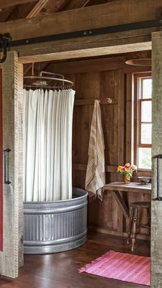 an open door leading to a bathroom with a tub and shower curtain in it's center