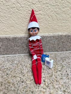 an elf is laying on the ground next to a wall