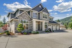 a large house with lots of windows and landscaping