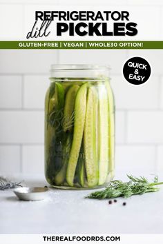 a jar filled with pickles sitting on top of a table