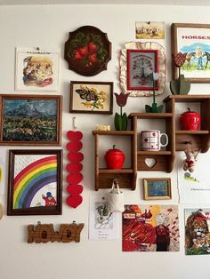 the wall is covered with many different pictures and framed art pieces, including bookshelves