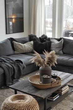 a living room filled with lots of furniture and pillows on top of a wooden table