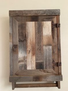 an old wooden box is hanging on the wall