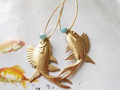 Statement earrings gold earrings gold fish  by iomiss iomissbisuteria@yahoo.es Handmade Ocean-inspired Gold Earrings, Gold Fish Jewelry, Brass Jewelry With Fish Hook For Gift, Gold Fish Earrings, Aquatic Earrings, Gold Fish-shaped Pierced Earrings, Elegant Gold Fish-shaped Earrings, Gold Fish-shaped Earrings, Gold Fish-shaped Earrings With Fish Hook