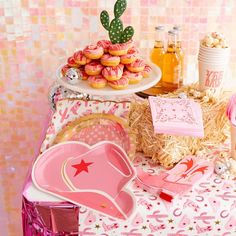 a table topped with lots of pink desserts and pastries on top of it