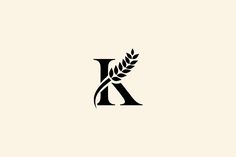 the letter k is made up of two branches and leaves, with one letter in the middle