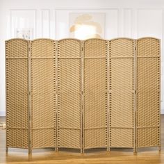 the room divider is made out of wicker and has four panels on each side