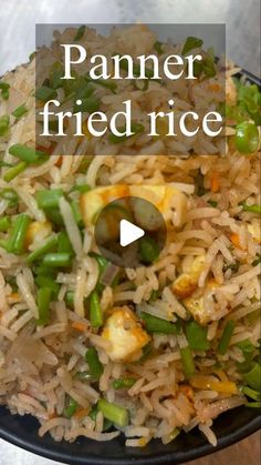 a bowl filled with rice and vegetables on top of a table