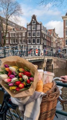 a basket full of food sitting on the side of a bridge next to a river