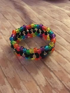 a rainbow & black kandi x cuff! ♡ ꒰ˆ◞⸝⸝◟ˆ ꒱੭ﾞ  ♡  36 beads in width  ♡  this listing is also up on mercari! Kandi Patterns Bracelets, Kandi Tutorial, Rainbow Kandi, Kandi Inspiration, Drake Funny, Bracelets Kandi, Scene Kandi, Pony Bead Animals, Loom Band Patterns