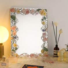 a mirror sitting on top of a table next to candles