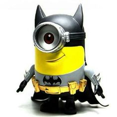 a minion with a batman costume on sitting in front of a white background and looking at the camera