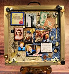 a collage of photos and magnets is displayed in a wooden frame on top of a table