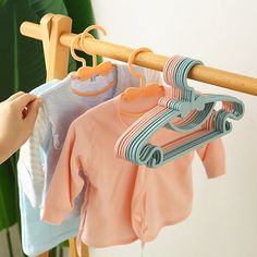 a person is hanging clothes on a rack