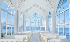 the interior of a church with rows of pews and windows overlooking the water in front of them