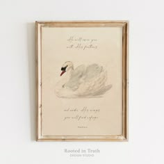 a painting hanging on the wall next to a framed piece of paper with an image of a swan