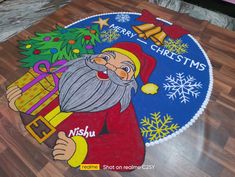 this is an image of a christmas mat with santa claus holding a present and the words merry christmas written on it