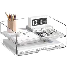 an alarm clock sitting on top of a desk next to a pen and pencil holder