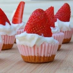 strawberry cupcakes with whipped cream and strawberries on a cutting board, ready to be eaten