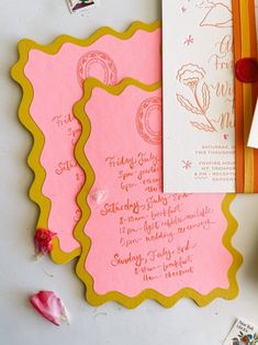 pink and yellow wedding stationery with envelopes