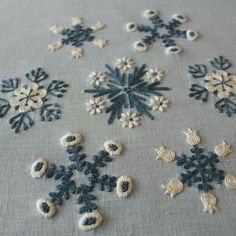 the snowflakes are made from crocheted yarns and have been stitched together