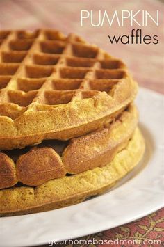 a stack of pumpkin waffles sitting on top of a white plate with the words pumpkin waffles above it