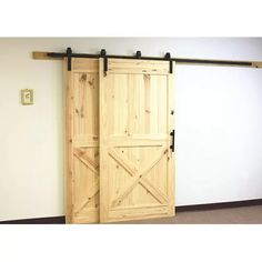 two wooden doors are open in an empty room