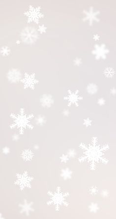 white snow flakes are flying in the air on a light gray background with space for text