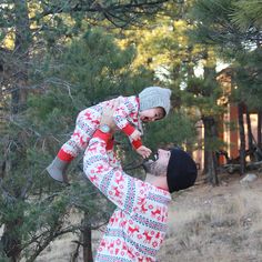 a man holding up a child in the air