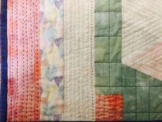 a close up of a quilted wall hanging