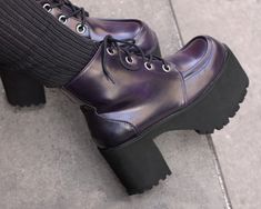 Add 3.5” of style to your step today! These durable and fashion forward platform boots provide an added lift to your style and are surprisingly easy to walk in! The purple rub-off leather is vegan friendly and made with eye-catching oversized silver eyelets. These boots are true vegan shoes for the environmentally conscious shoe shopper! Purple Heeled Boots, Purple Boots Aesthetic, Whimsigoth Shoes, Purple Fashion Aesthetic, Dark Purple Shoes, Purple Platforms, Witchy Shoes, Purple Clothes, Creeper Boots