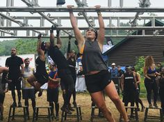 a group of people hanging upside down in the air with their hands up and feet apart