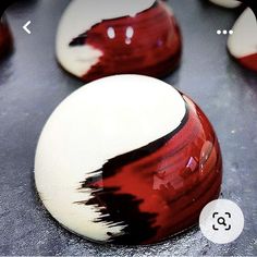 several red and white marbles sitting on top of a table