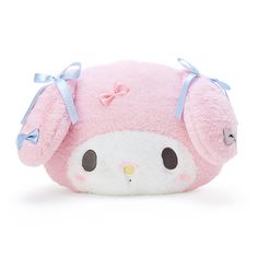 a pink and white stuffed animal with bows on it's head, sitting in front of a white background