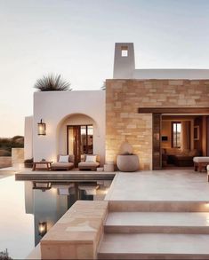 an outdoor living area with steps leading to the pool