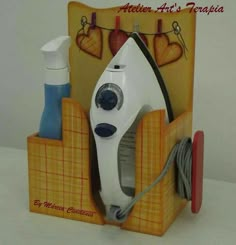 an electric iron is sitting on top of a box with other items in it,