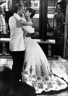 a man and woman dance together in an old photo