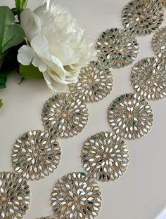 Round Gold Real Mirror Band Embellishment - 6cm Wide Indian Lace Border by Yard Elevate your designs with this 6cm Round Gold Real Mirror Band Embellishment. Perfect for adding a touch of luxury to saris, lehengas, gowns, and wedding dresses. This versatile lace border is ideal for creating stunning belts and elegant dress trims 🌟✨. Materials: Gold Real Mirrors Indian Lace Embellished Detailing Uses: Sari Borders: Adds a glamorous edge. Lehengas & Gowns: Enhances with a luxurious touch. Wedding Lehenga Belt Design, Luxury Ceremonial Jewelry With Mirror Work, Luxury Mirror Work Jewelry For Festivals, Mirror Lace, Festive Dress, Mirror Trim, Lehenga Gown, Dress Trims, Wedding Dress Belt