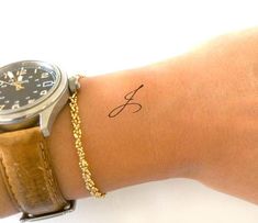 a woman's wrist with a watch on it and a chain around the wrist