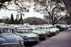 many old cars are parked on the side of the road